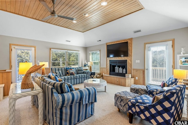 living room with carpet, a healthy amount of sunlight, wainscoting, and visible vents