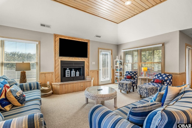 living area featuring carpet, a wainscoted wall, and visible vents