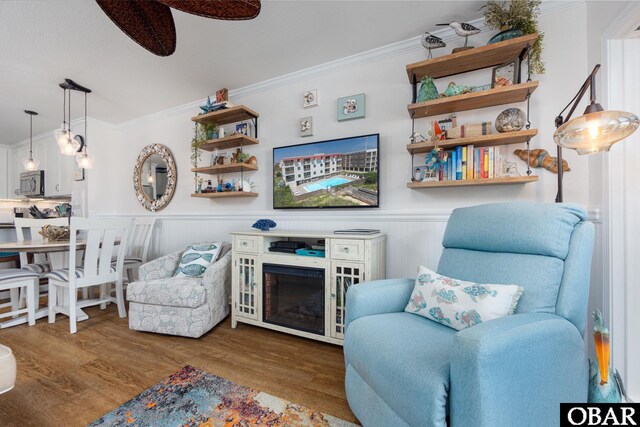 5515 S Virginia Dare Trl Unit B-3, Nags Head, NC 27959 - living room with ornamental molding, wood finished floors, a ceiling fan, and wainscoting