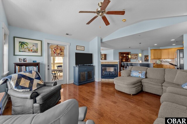 100F Mercedes Ct Unit F, Grandy, NC 27939 - living area featuring lofted ceiling, a ceiling fan, light wood-style floors, a tile fireplace, and recessed lighting