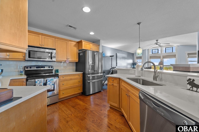 100F Mercedes Ct Unit F, Grandy, NC 27939 - kitchen with stainless steel appliances, a sink, light countertops, decorative backsplash, and dark wood-style flooring