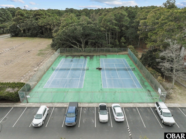 view of tennis court featuring fence