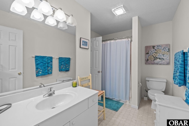 bathroom with tile patterned floors, toilet, curtained shower, a textured ceiling, and vanity