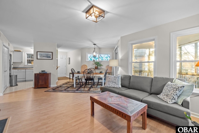 living area featuring light wood-type flooring and baseboards