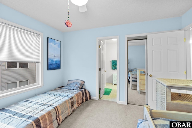 bedroom featuring a closet, ceiling fan, baseboards, and carpet floors