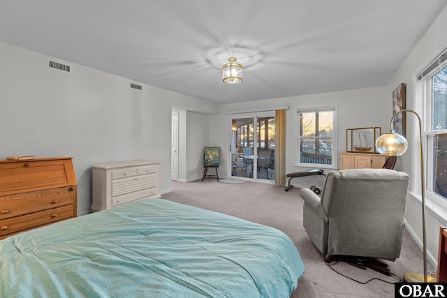 carpeted bedroom with access to exterior, visible vents, and baseboards