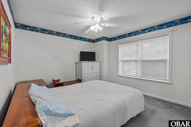 bedroom featuring baseboards, carpet floors, a textured ceiling, and ceiling fan