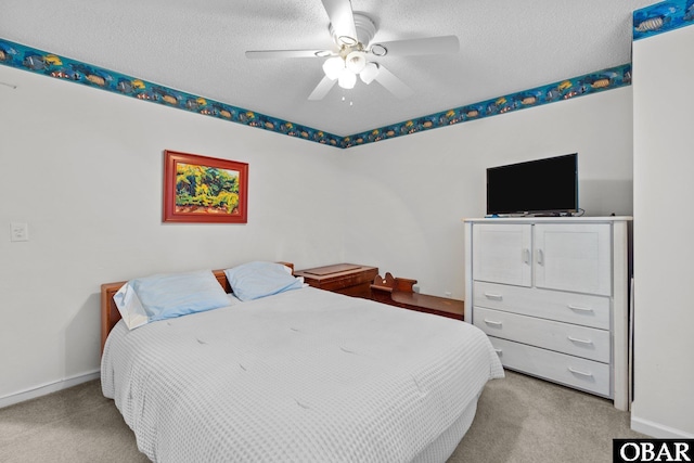 bedroom with baseboards, a textured ceiling, and carpet flooring