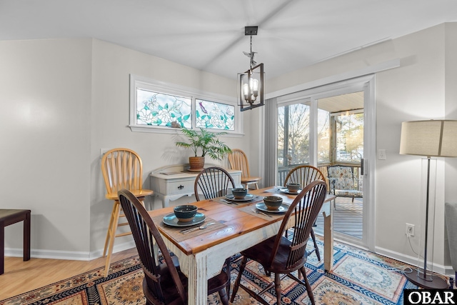 dining area featuring light wood-type flooring and baseboards