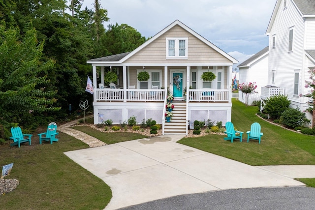 view of front of house featuring a porch, stairway, and a front yard