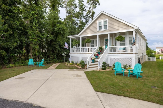 view of front of property featuring a porch, a front lawn, and stairs