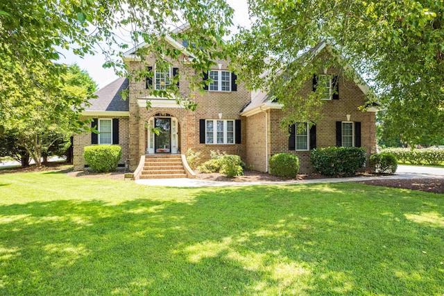 view of front facade featuring crawl space, roof with shingles, a front lawn, and brick siding