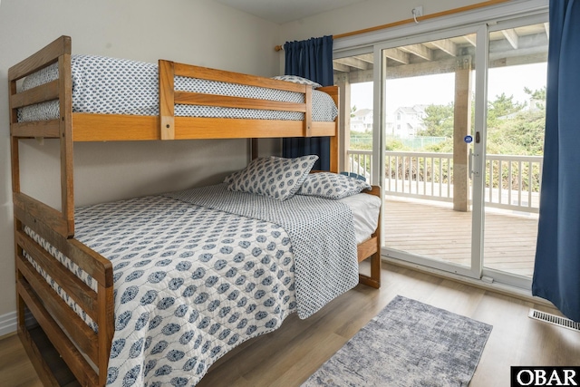 bedroom featuring visible vents, multiple windows, and light wood-style flooring