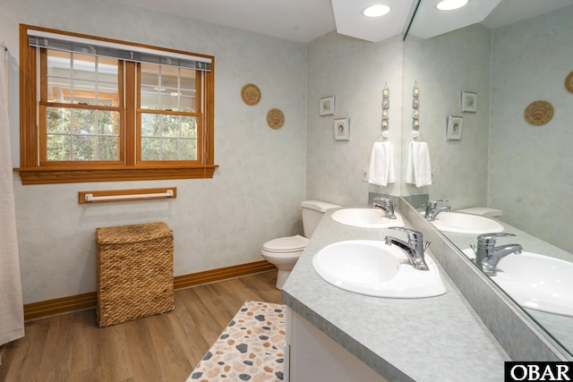 full bath with a sink and wood finished floors