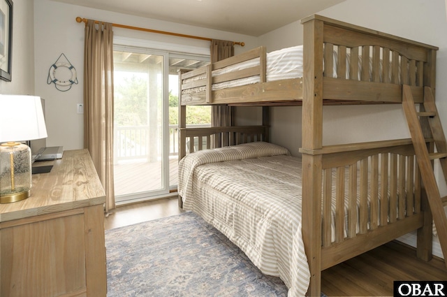 bedroom featuring access to outside and dark wood finished floors