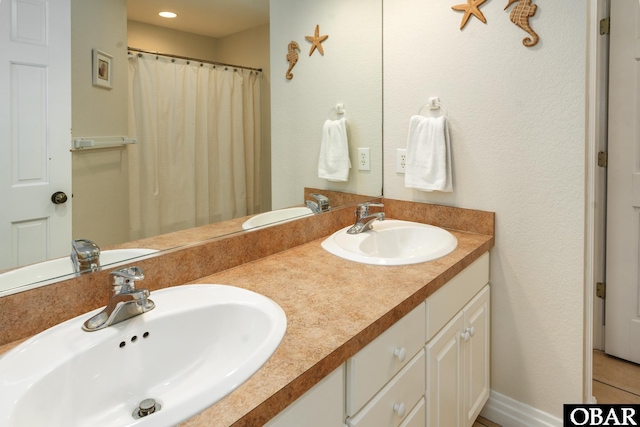 bathroom with double vanity and a sink