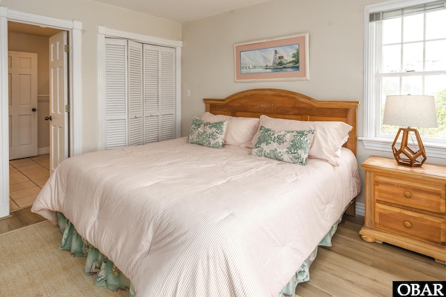 bedroom featuring a closet and light wood finished floors