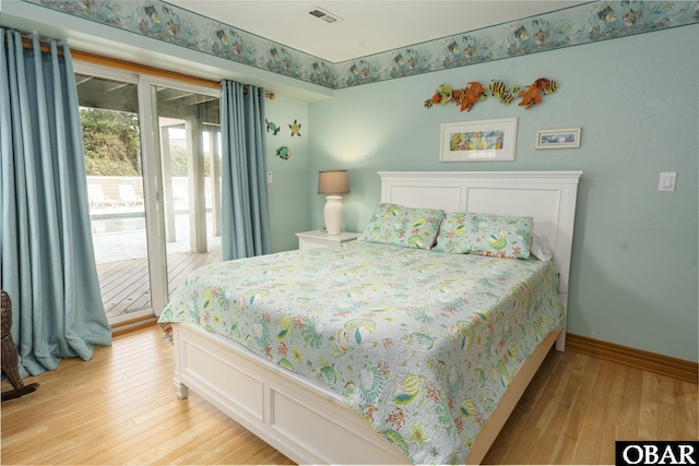 bedroom featuring access to exterior, baseboards, visible vents, and light wood finished floors