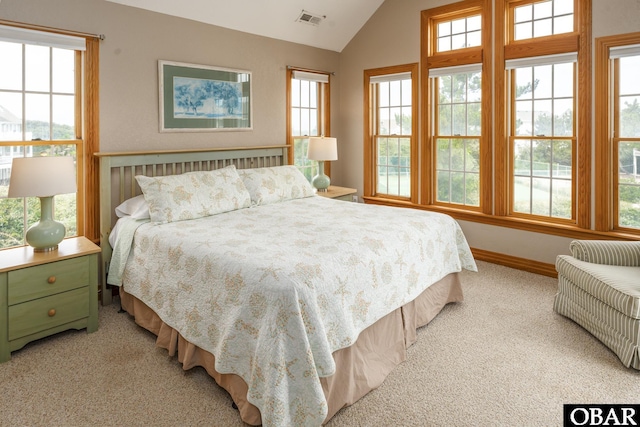 bedroom with vaulted ceiling, carpet flooring, visible vents, and baseboards