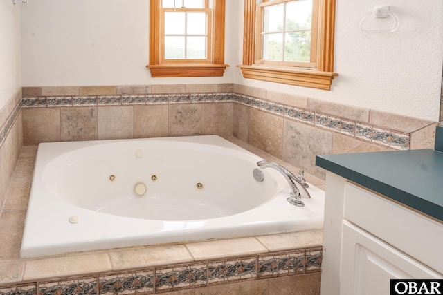 full bath featuring vanity and a whirlpool tub