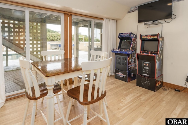 dining area with baseboards and wood finished floors