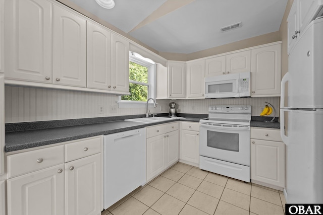410 W Wilkinson St Lot 26-28, Kill Devil Hills, NC 27948 - kitchen featuring white appliances, dark countertops, light tile patterned flooring, and white cabinets