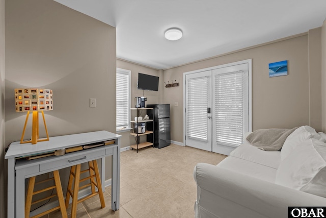 410 W Wilkinson St Lot 26-28, Kill Devil Hills, NC 27948 - living area featuring light tile patterned floors and baseboards