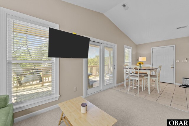 410 W Wilkinson St Lot 26-28, Kill Devil Hills, NC 27948 - living room with lofted ceiling, light colored carpet, and light tile patterned floors