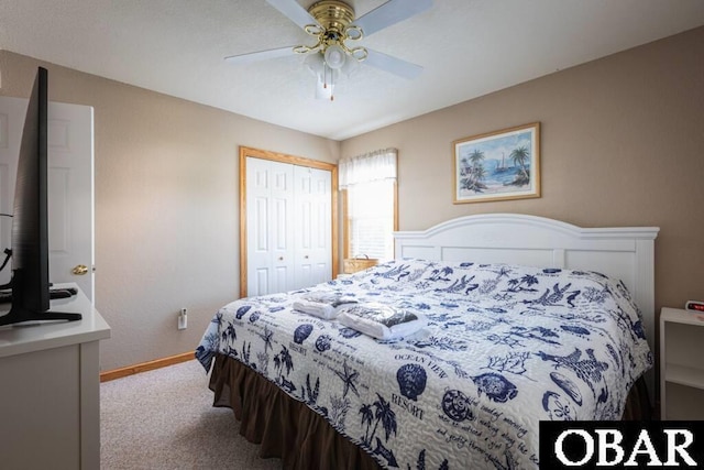 bedroom with a closet, carpet flooring, a ceiling fan, and baseboards