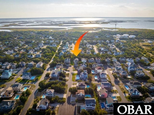 birds eye view of property featuring a water view and a residential view