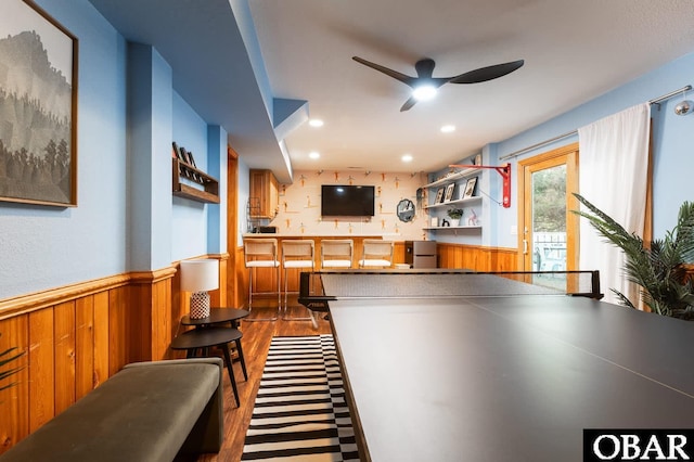 interior space featuring dark wood-style floors, a wainscoted wall, recessed lighting, a ceiling fan, and wood walls