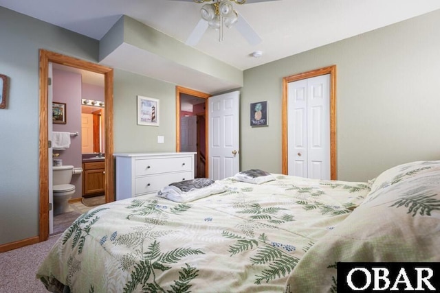 bedroom with connected bathroom, carpet floors, a ceiling fan, baseboards, and a closet