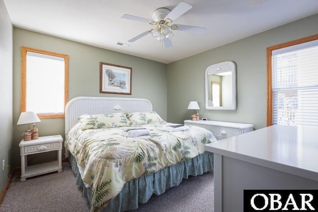 carpeted bedroom featuring ceiling fan and visible vents