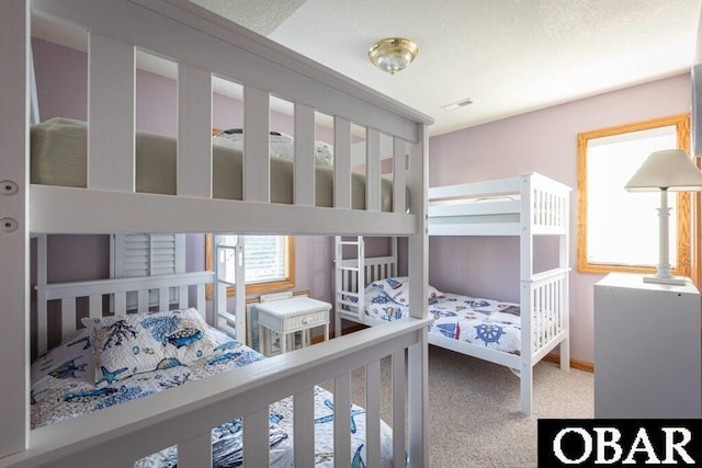 bedroom featuring carpet floors, visible vents, and baseboards