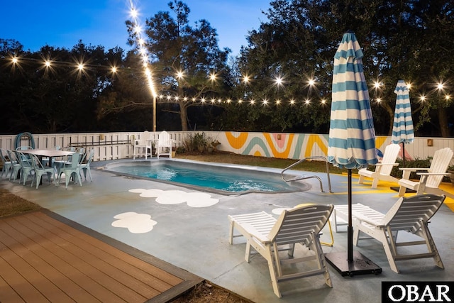 community pool featuring a patio and fence