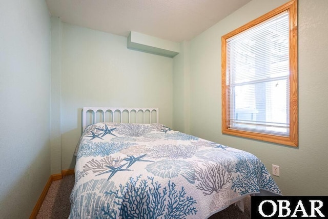 carpeted bedroom featuring baseboards