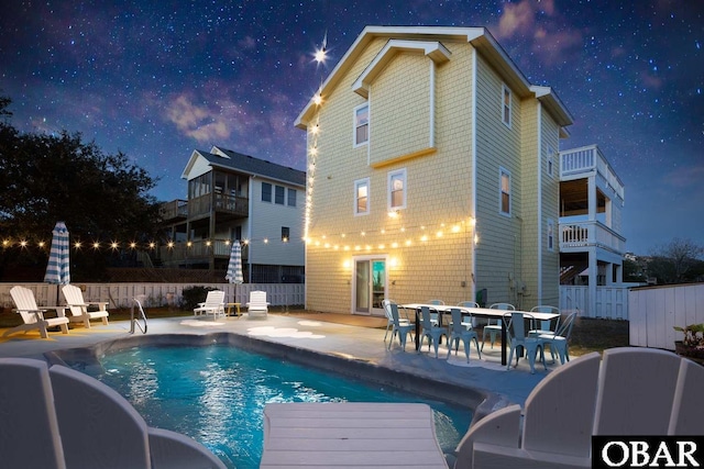 view of swimming pool featuring a fenced in pool, a patio area, and fence