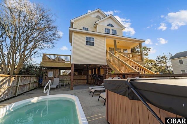 back of house with a fenced in pool, a patio, fence, a wooden deck, and stairs