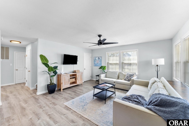 living room featuring visible vents, a wealth of natural light, light wood-style flooring, and baseboards