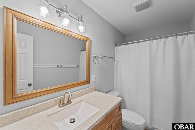 full bath with visible vents, vanity, and toilet