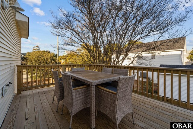 wooden deck featuring outdoor dining area