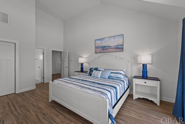 bedroom with high vaulted ceiling, baseboards, visible vents, and dark wood-type flooring