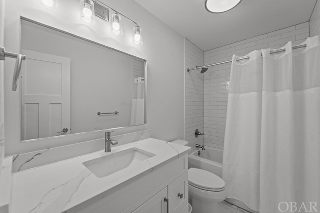 bathroom with toilet, shower / bath combo, and vanity