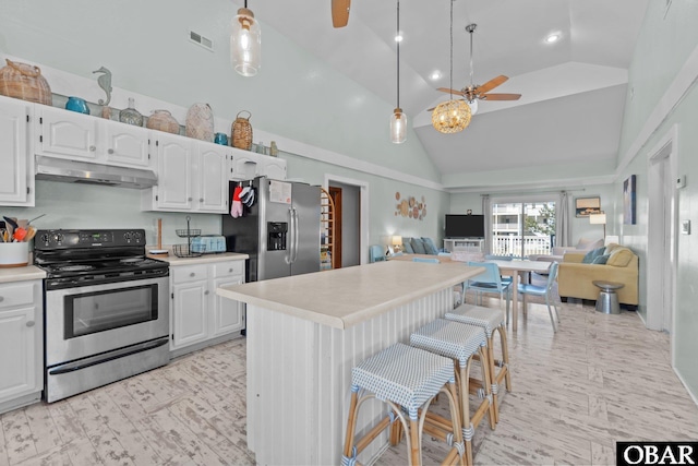 1017 Corolla Dr Lot 52, Corolla, NC 27927 - kitchen featuring stainless steel appliances, under cabinet range hood, a ceiling fan, high vaulted ceiling, and open floor plan