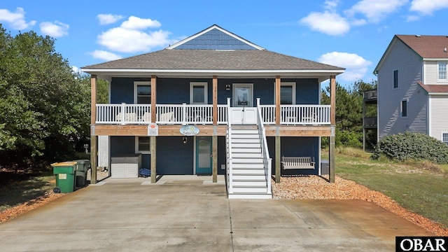 1017 Corolla Dr Lot 52, Corolla, NC 27927 - beach home with a porch, stairway, a shingled roof, and driveway