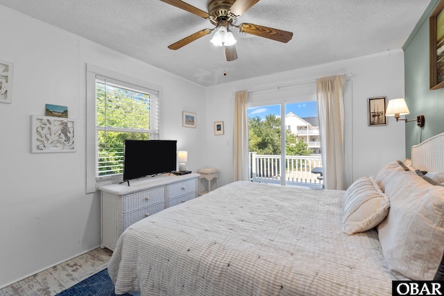 1017 Corolla Dr Lot 52, Corolla, NC 27927 - bedroom featuring access to outside, ceiling fan, a textured ceiling, and baseboards