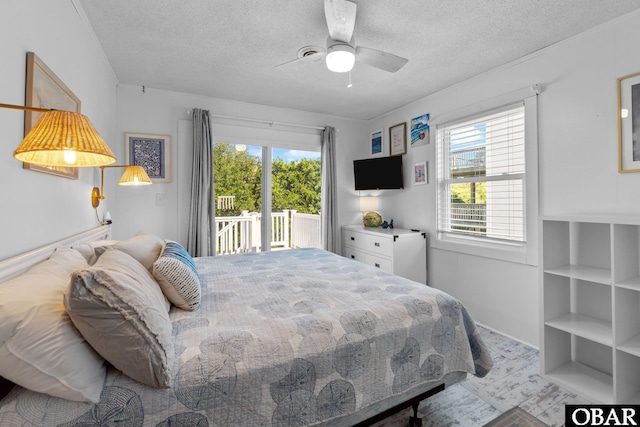 1017 Corolla Dr Lot 52, Corolla, NC 27927 - bedroom featuring access to exterior, a textured ceiling, and ceiling fan