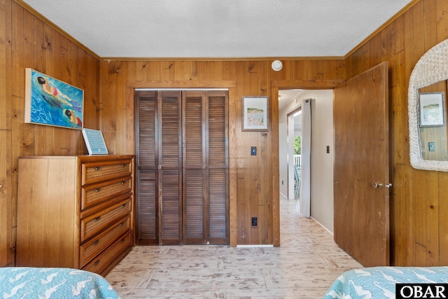 1017 Corolla Dr Lot 52, Corolla, NC 27927 - bedroom with wooden walls, a closet, a textured ceiling, and ornamental molding