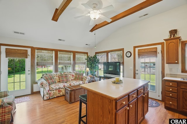 184 Tabernacle Ln, Aydlett, NC 27916 - kitchen with light wood-style flooring, light countertops, a breakfast bar area, and a center island