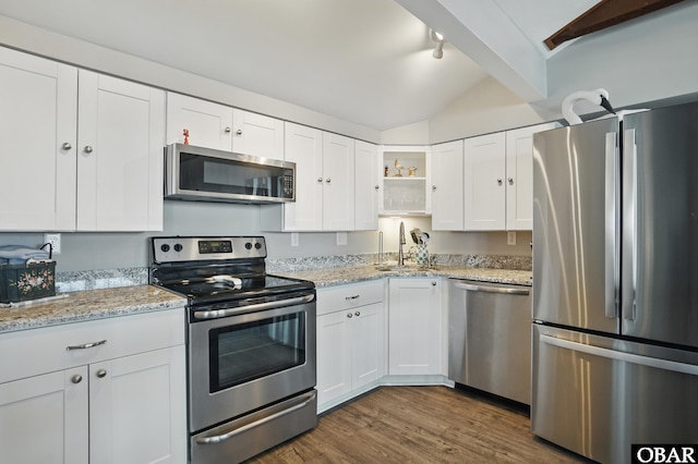 184 Tabernacle Ln, Aydlett, NC 27916 - kitchen featuring stainless steel appliances, open shelves, white cabinetry, dark wood-style flooring, and light stone counters